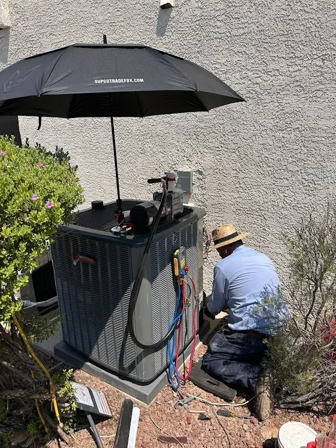 HVAC technician performing outdoor AC maintenance in Lubbock