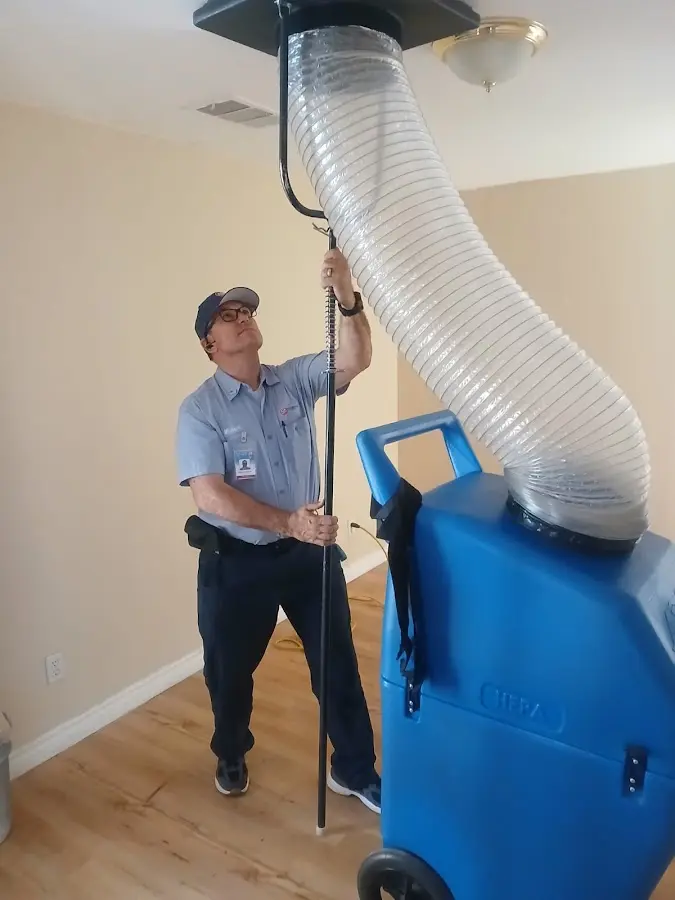 Furnace Tune-Up technician using HEPA equipment in Lubbock